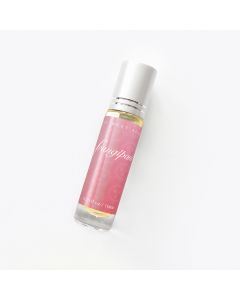 Clear rollerball bottle with silver cap containing perfume, labeled "frangipani" on a pink background. Minimalist design on a white surface.